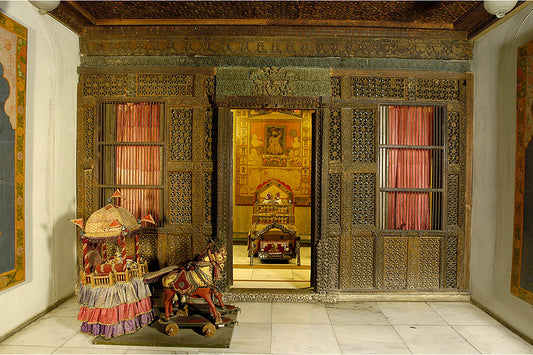 An elaborately carved doorway to a shrine Image Courtesy Calico Museum - Sarabhai Foundation, Ahmedabad.